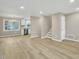 Spacious living area featuring wood floors, white walls, and contemporary lighting, adjacent to the kitchen at 1041 Limerick Ln, Durham, NC 27713