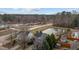 Aerial view of a property with a nearby pond and view of surrounding community at 1104 Pebblestone Dr, Durham, NC 27703
