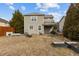 Spacious backyard with a covered patio, a small fire pit, and some trees at 1104 Pebblestone Dr, Durham, NC 27703