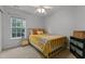 Bright bedroom featuring a large window and ceiling fan at 1104 Pebblestone Dr, Durham, NC 27703