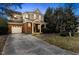 Charming two-story home with brick facade, attached garage, and manicured landscaping at 1104 Pebblestone Dr, Durham, NC 27703