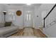 Bright entryway with stylish front door, hardwood floors, staircase, and large analog clock at 1104 Pebblestone Dr, Durham, NC 27703
