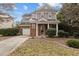 Two-story home with brick and siding, a front porch, and an attached garage at 1104 Pebblestone Dr, Durham, NC 27703