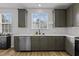 This kitchen boasts dark green cabinets, stainless steel appliances, and plenty of countertop space at 1104 Pebblestone Dr, Durham, NC 27703