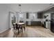Open kitchen with stainless steel appliances, eat in dining, neutral color cabinets, and hardwood floors at 1104 Pebblestone Dr, Durham, NC 27703