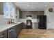 Bright kitchen with sleek countertops, stainless steel dishwasher, black appliances, and plentiful storage at 1104 Pebblestone Dr, Durham, NC 27703