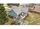 Aerial view of a green home featuring a back deck and patio in a landscaped backyard at 115 N Oakland Dr, Mebane, NC 27302