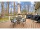 A charming back deck includes table, umbrella, grill and a pergola, perfect for outdoor living at 115 N Oakland Dr, Mebane, NC 27302