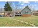 A spacious backyard features a patio and steps leading up to the deck at 115 N Oakland Dr, Mebane, NC 27302