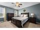 Comfortable bedroom with ceiling fan, two windows and neutral decor at 115 N Oakland Dr, Mebane, NC 27302