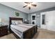 Bedroom with a dark wood bed frame and matching nightstands and an attached bath at 115 N Oakland Dr, Mebane, NC 27302