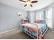 Bright bedroom with big windows and a bed with floral bedding, offering a cozy and inviting atmosphere at 115 N Oakland Dr, Mebane, NC 27302