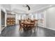 Open dining room with a round wooden table, guitars, and shelving with wine glasses at 115 N Oakland Dr, Mebane, NC 27302