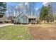 Charming single-Gathering home boasts a cozy front porch and inviting curb appeal with mature landscaping at 115 N Oakland Dr, Mebane, NC 27302