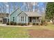 Charming single-Gathering home boasts a cozy front porch and inviting curb appeal with mature landscaping at 115 N Oakland Dr, Mebane, NC 27302