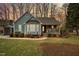 Charming single-Gathering home boasts a cozy front porch and inviting curb appeal with mature landscaping at 115 N Oakland Dr, Mebane, NC 27302