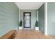 Inviting front porch features a bench, potted plants, and a welcome mat for a warm greeting at 115 N Oakland Dr, Mebane, NC 27302