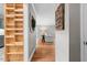 Hallway with a view of a living room and built-in shelving on the side at 115 N Oakland Dr, Mebane, NC 27302