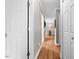 Hallway with wood floors and multiple doorways leading to other rooms at 115 N Oakland Dr, Mebane, NC 27302