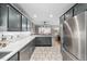 Open-concept kitchen with stainless appliances and tile backsplash at 115 N Oakland Dr, Mebane, NC 27302