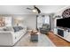 Cozy living room with hardwood floors, ceiling fan, and a comfortable seating arrangement at 115 N Oakland Dr, Mebane, NC 27302