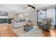 Cozy living room with hardwood floors, ceiling fan, and a comfortable seating arrangement at 115 N Oakland Dr, Mebane, NC 27302