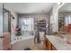 Bright bathroom with a corner tub, window, sink with wooden cabinets, and floral accents at 11843 Canemount St, Raleigh, NC 27614