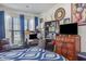 This bedroom is set up as a home office with custom shelving, a window view, and comfortable furniture at 11843 Canemount St, Raleigh, NC 27614