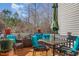 Outdoor deck area featuring comfortable cushioned seating, a glass table, and a relaxing ambiance at 11843 Canemount St, Raleigh, NC 27614