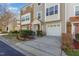 Well-maintained townhome featuring stone accents, an attached garage and mature landscaping at 11843 Canemount St, Raleigh, NC 27614