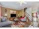 Cozy living room featuring a ceiling fan, wooden floors, and comfortable seating arrangement at 11843 Canemount St, Raleigh, NC 27614