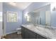 Light and airy bathroom featuring a marble countertop vanity, toilet, and a bright window at 1216 York St, Rocky Mount, NC 27803