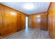 Bedroom featuring classic wood paneling, ample closet space, and neutral flooring for a cozy, timeless feel at 1216 York St, Rocky Mount, NC 27803