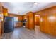 Functional kitchen with wood paneling, featuring essential appliances and ample cabinet space at 1216 York St, Rocky Mount, NC 27803