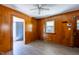 Cozy living room with wood paneling, ceiling fan, and natural light from a window, creating a warm atmosphere at 1216 York St, Rocky Mount, NC 27803