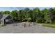 Community basketball court surrounded by mature trees and greenery, perfect for outdoor activities at 122 Weavers Grove Dr, Chapel Hill, NC 27514