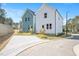 View of two backyards with concrete driveway separating the adjacent homes at 122 Weavers Grove Dr, Chapel Hill, NC 27514