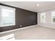 A spacious bedroom features neutral carpet, two large windows, and fresh paint at 122 Weavers Grove Dr, Chapel Hill, NC 27514