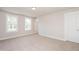 A spacious bedroom features neutral carpet, two large windows, and fresh paint at 122 Weavers Grove Dr, Chapel Hill, NC 27514