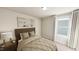 Cozy bedroom with modern lamp and furniture, soft carpet, and natural light through the window at 122 Weavers Grove Dr, Chapel Hill, NC 27514