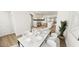 Bright dining room with white chairs, decorative chandelier, and view to the kitchen at 122 Weavers Grove Dr, Chapel Hill, NC 27514