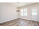 A dining area featuring a modern chandelier and large windows providing lots of natural light at 122 Weavers Grove Dr, Chapel Hill, NC 27514