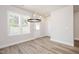 A dining area featuring a modern chandelier and large windows providing lots of natural light at 122 Weavers Grove Dr, Chapel Hill, NC 27514