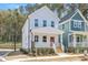 Charming two-story home featuring a welcoming front porch with a vibrant red door at 122 Weavers Grove Dr, Chapel Hill, NC 27514
