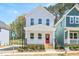 Charming two-story home featuring a welcoming front porch with a vibrant red door at 122 Weavers Grove Dr, Chapel Hill, NC 27514