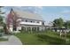 Modern two-story home boasting a metal roof, inviting front porch, lush landscaping, and a spacious green lawn at 122 Weavers Grove Dr, Chapel Hill, NC 27514