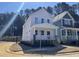 Lovely two-story home with a red door, white trim, and a welcoming front porch surrounded by new landscaping at 122 Weavers Grove Dr, Chapel Hill, NC 27514