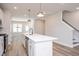 Modern kitchen featuring a large island with sink, stainless steel appliances and stylish lighting at 122 Weavers Grove Dr, Chapel Hill, NC 27514