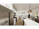 Bright kitchen featuring white cabinets, stainless steel appliances, and a large island with pendant lighting at 122 Weavers Grove Dr, Chapel Hill, NC 27514