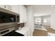 Modern kitchen featuring stainless steel microwave and white cabinetry adjacent to a dining area at 122 Weavers Grove Dr, Chapel Hill, NC 27514